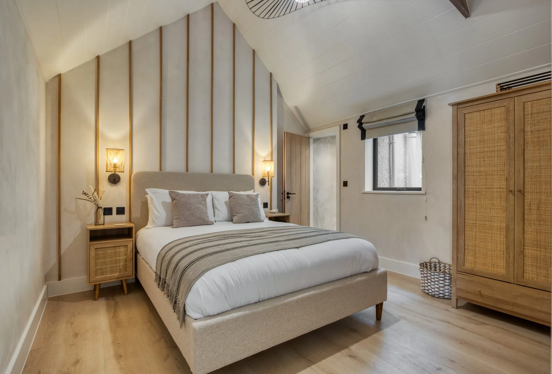 Bedroom in a Gower holiday apartment with soft boucle and linen textures